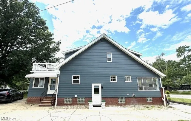 View of side of home featuring a balcony