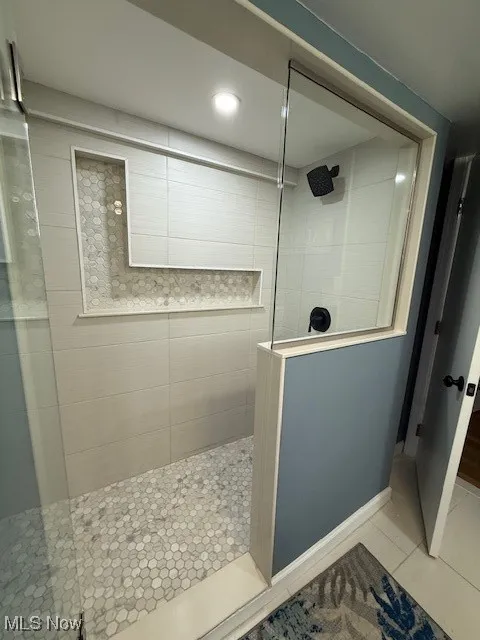 Bathroom with walk in shower, tile patterned flooring, and recessed lighting