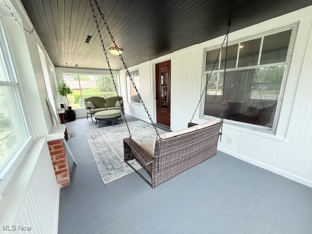 Sunroom featuring wood ceiling