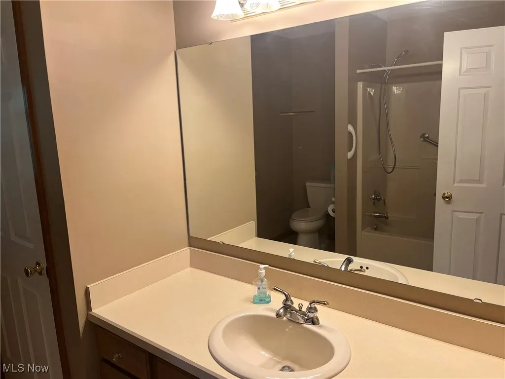 Full bath featuring shower / washtub combination and vanity