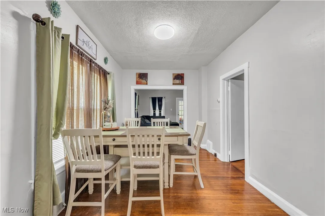 Dining area featuring a textured ceiling and wood finished floors