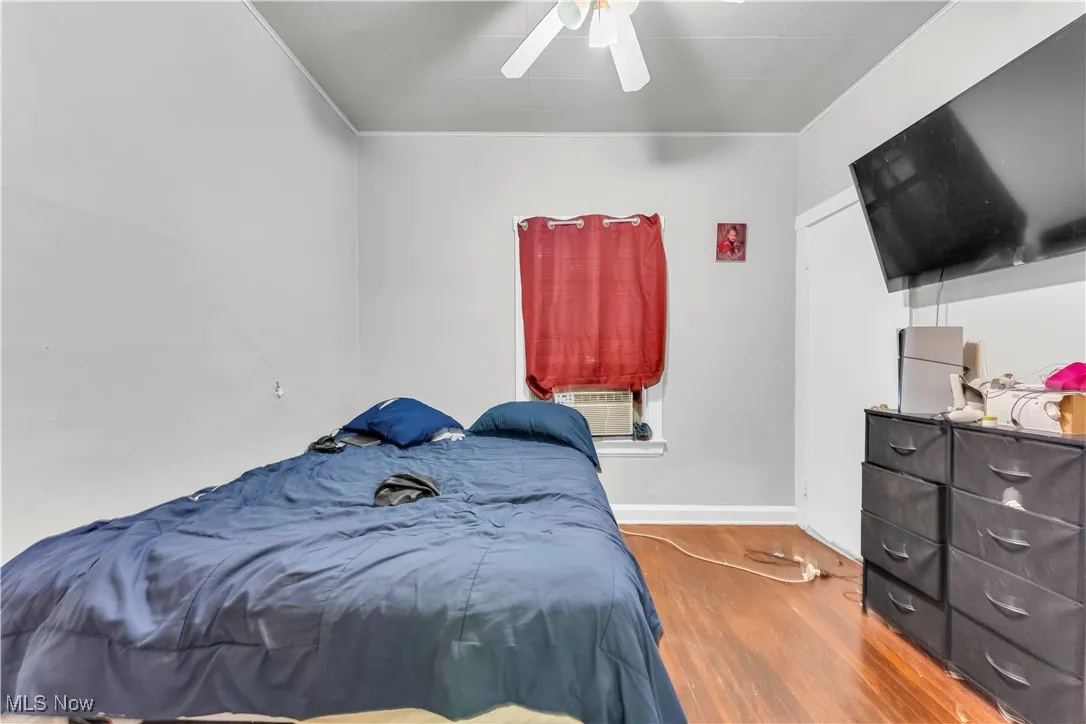 Bedroom featuring wood finished floors and ceiling fan