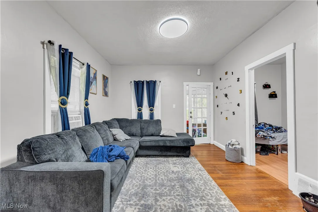 Living area featuring wood finished floors and a textured ceiling