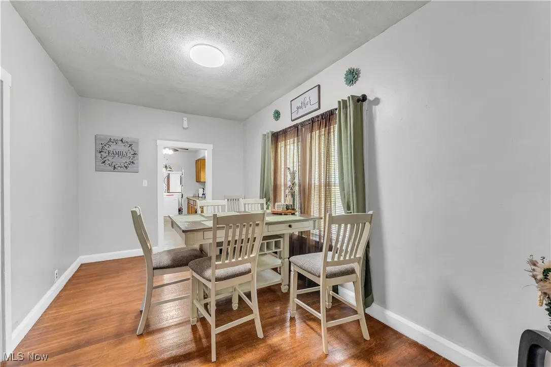Dining space with light wood-style floors and a textured ceiling