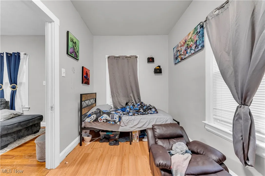 Bedroom with light wood-type flooring and baseboards