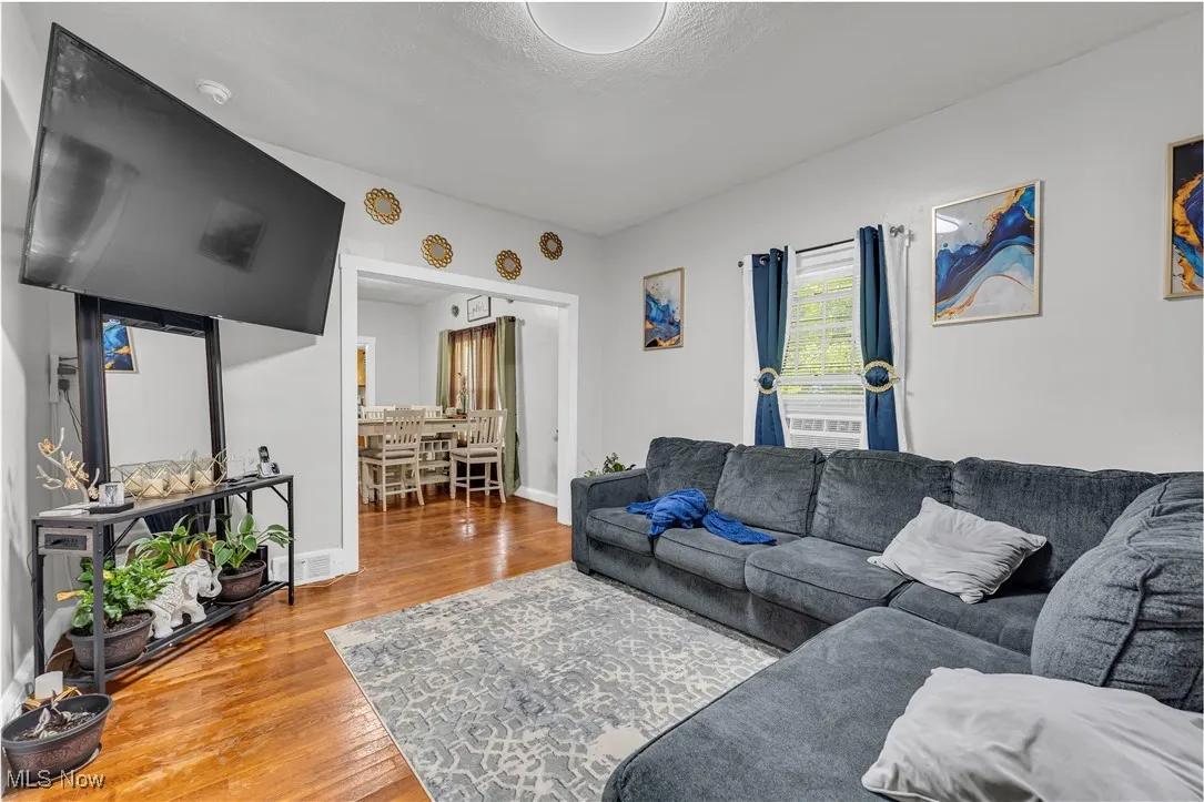 Living room featuring light wood-type flooring and baseboards