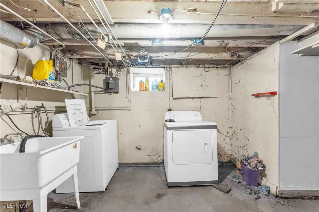 Washroom featuring washing machine and dryer