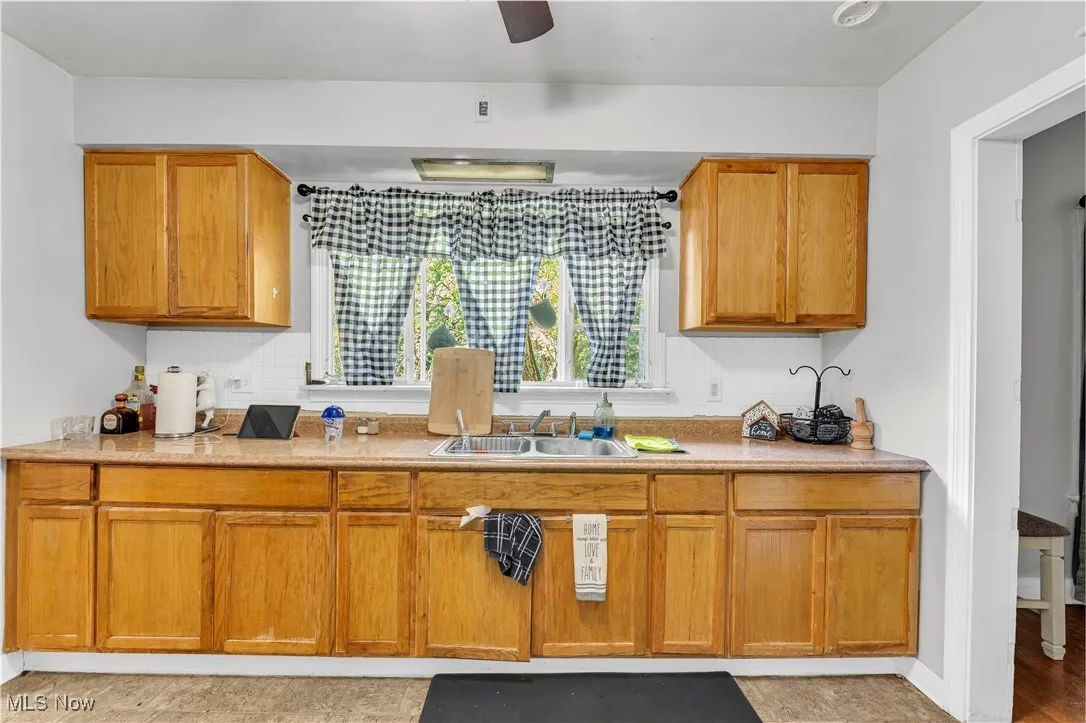 Kitchen with light countertops and brown cabinetry