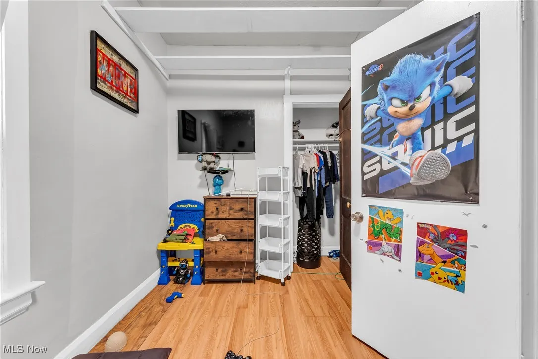 Rec room with wood finished floors and baseboards