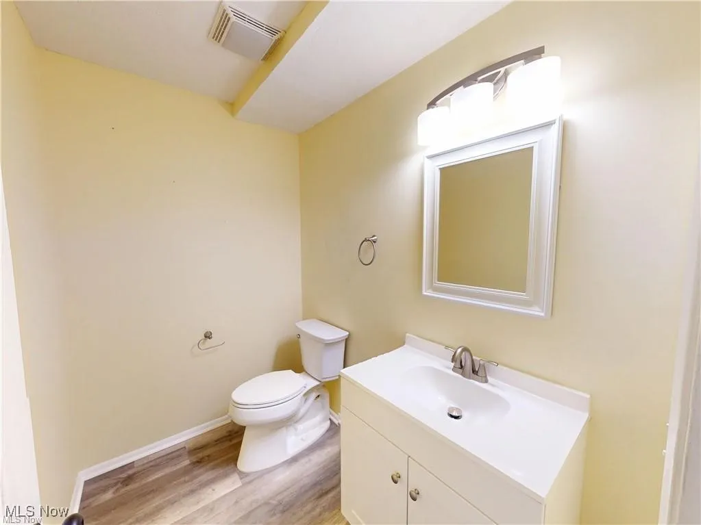 Half bath with vanity and light wood-style flooring