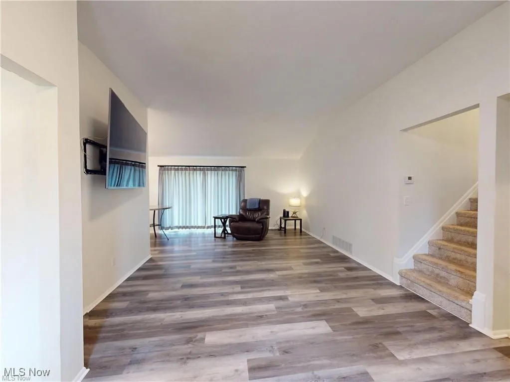 Living area featuring light wood-type flooring and stairs