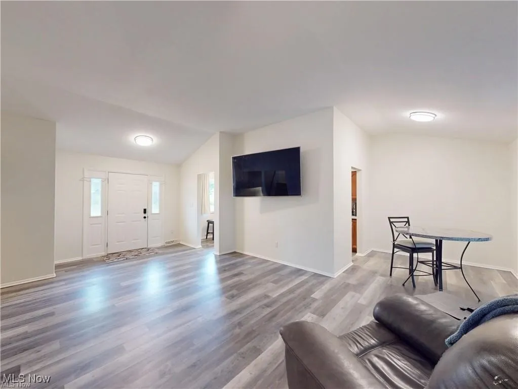 Living area featuring lofted ceiling and light wood-style flooring