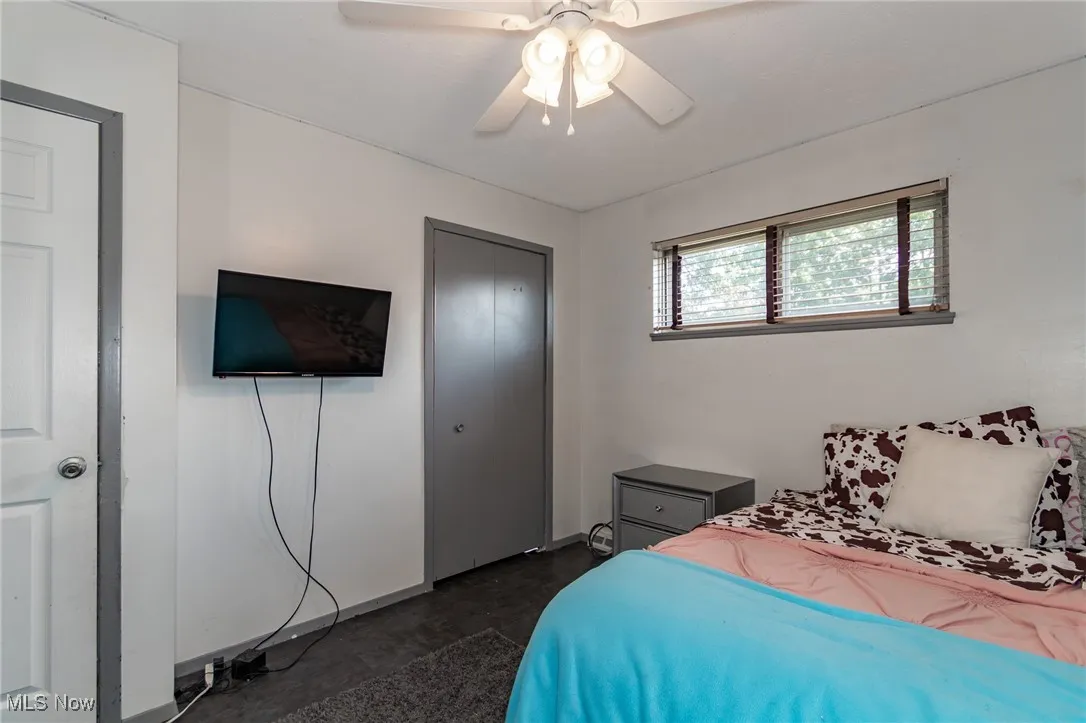 Bedroom with a ceiling fan and a closet