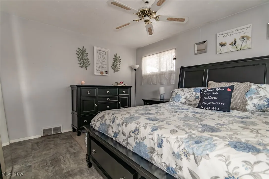 Bedroom with ceiling fan and baseboards