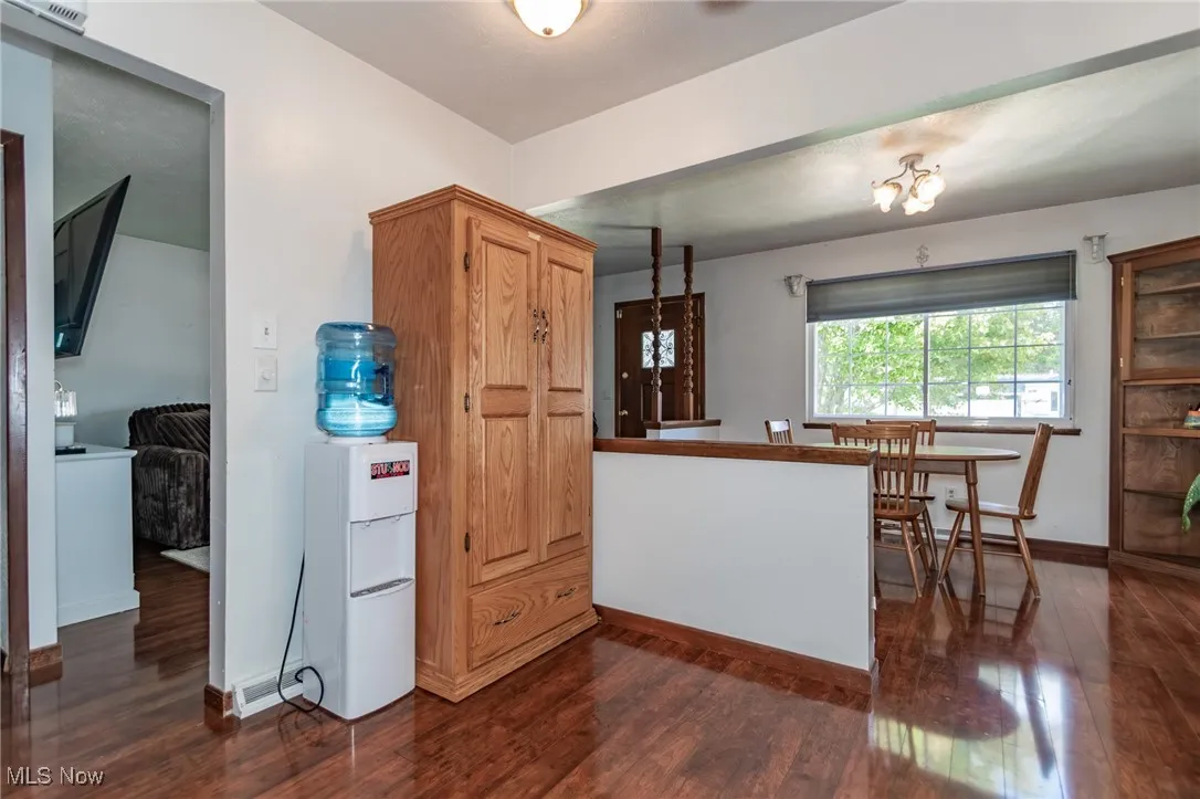 Kitchen featuring baseboards and dark wood-style flooring