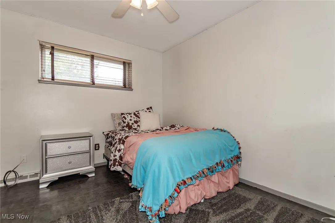 Bedroom with a ceiling fan and vaulted ceiling