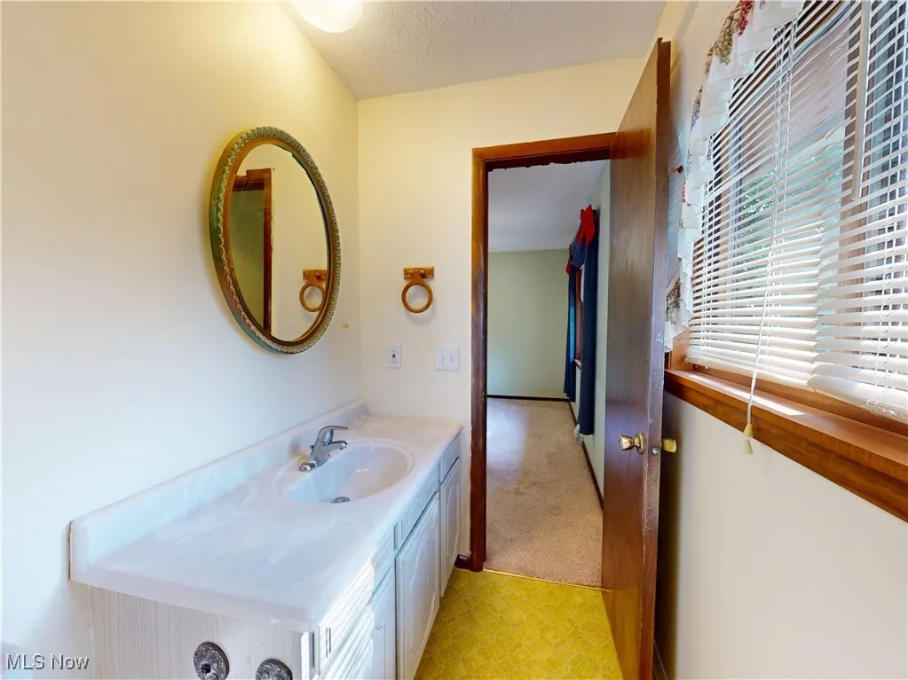 Bathroom featuring vanity and a textured ceiling
