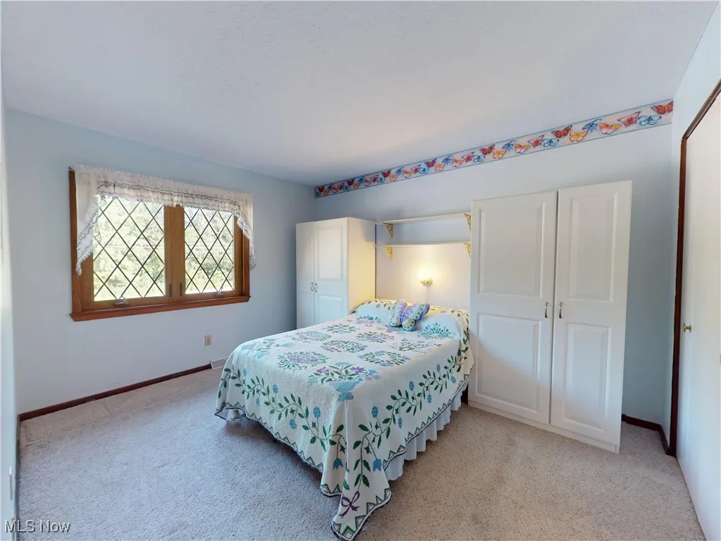 Bedroom featuring a closet and light carpet