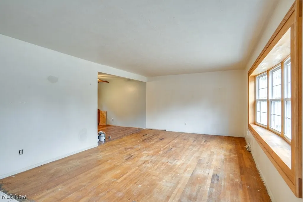 Unfurnished room featuring hardwood flooring
