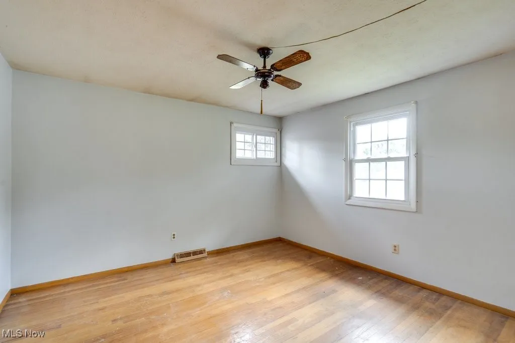 Spare room with light wood-style floors and ceiling fan