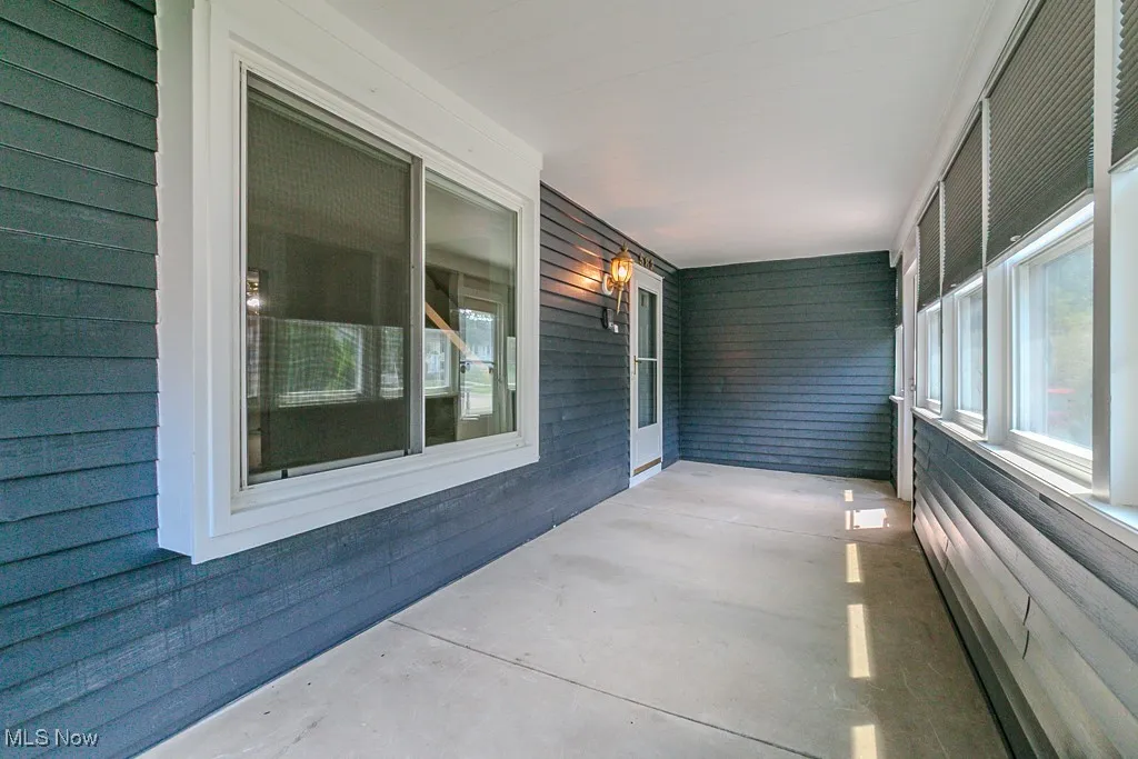 Fully enclosed sunroom/patio at the front of the house.