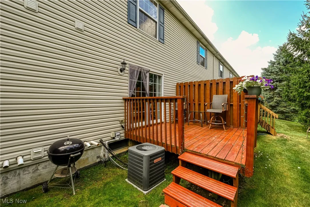 Wooden deck with a lawn and area for grilling