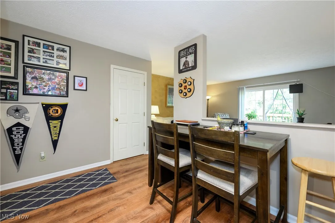 Dining space featuring light wood-type flooring and a textured ceiling