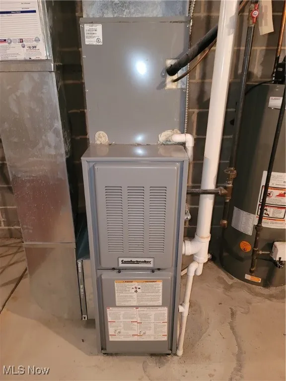 Utility room with water heater and heating unit