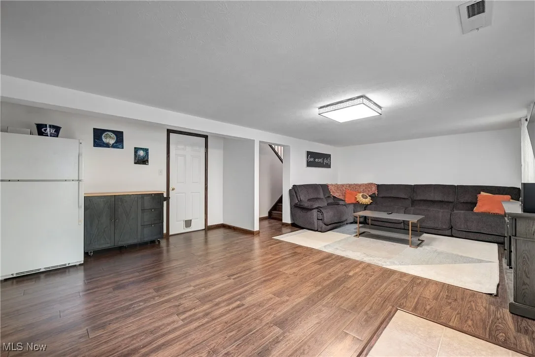 Living room with wood finished floors and stairs