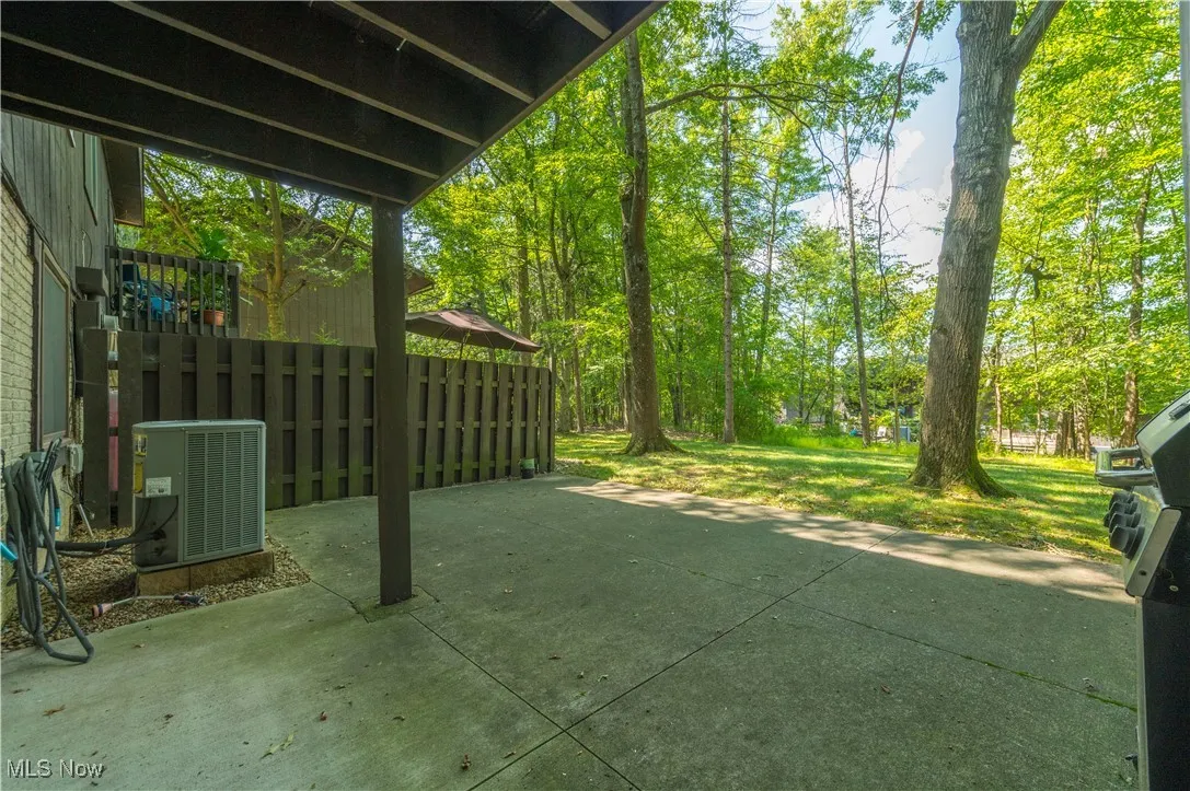 View of grassy yard featuring a patio