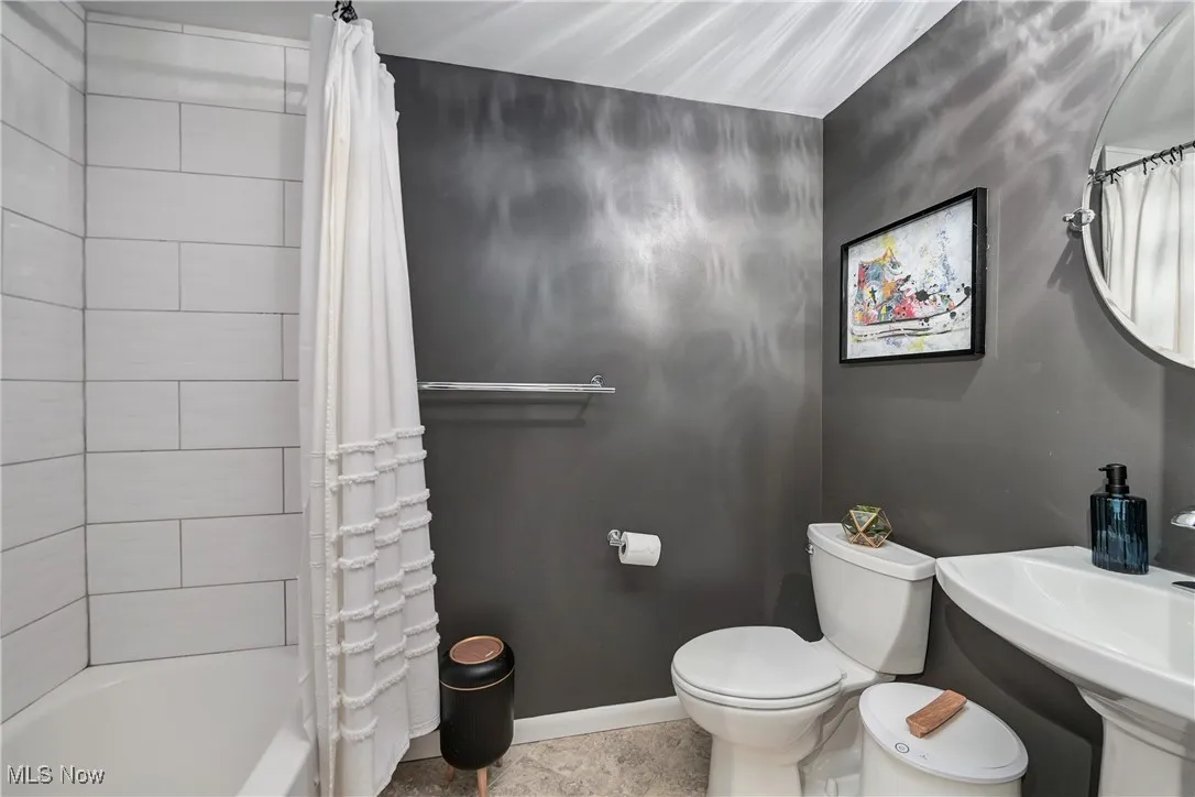Bathroom with shower / bath combo and toilet