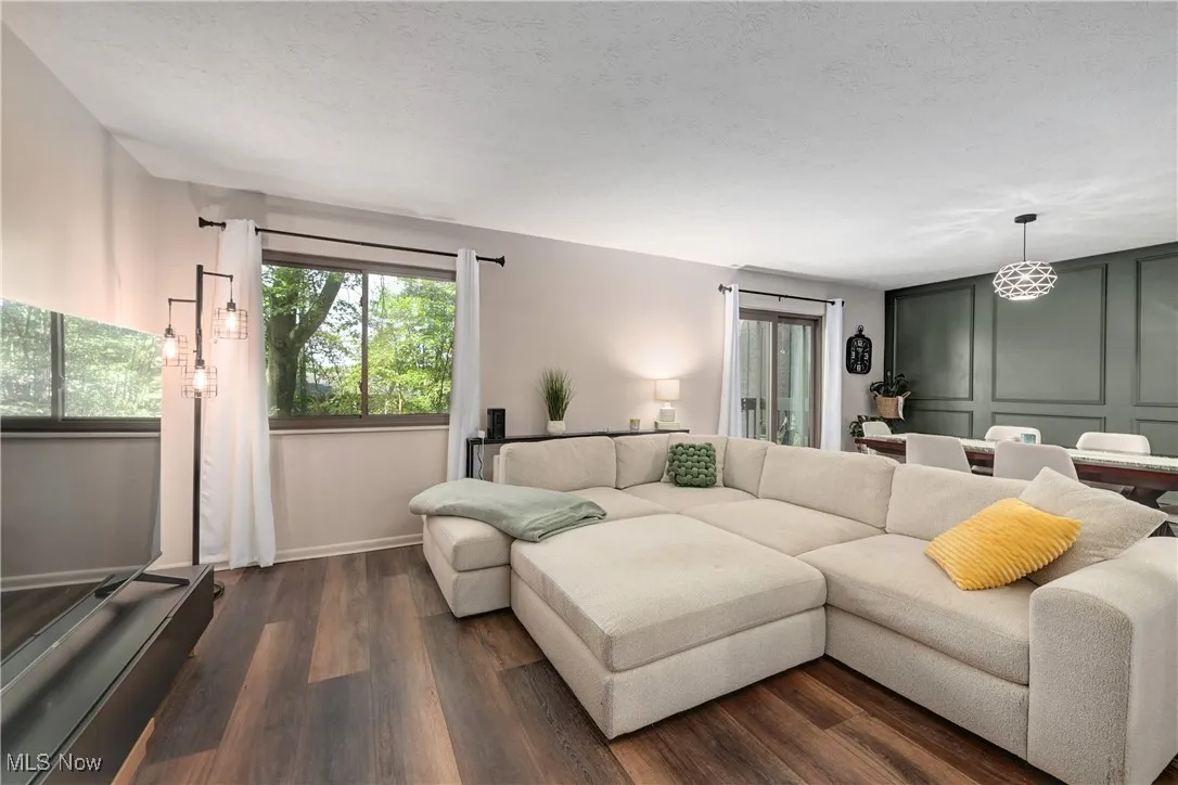 Living area with dark wood finished floors and a textured ceiling
