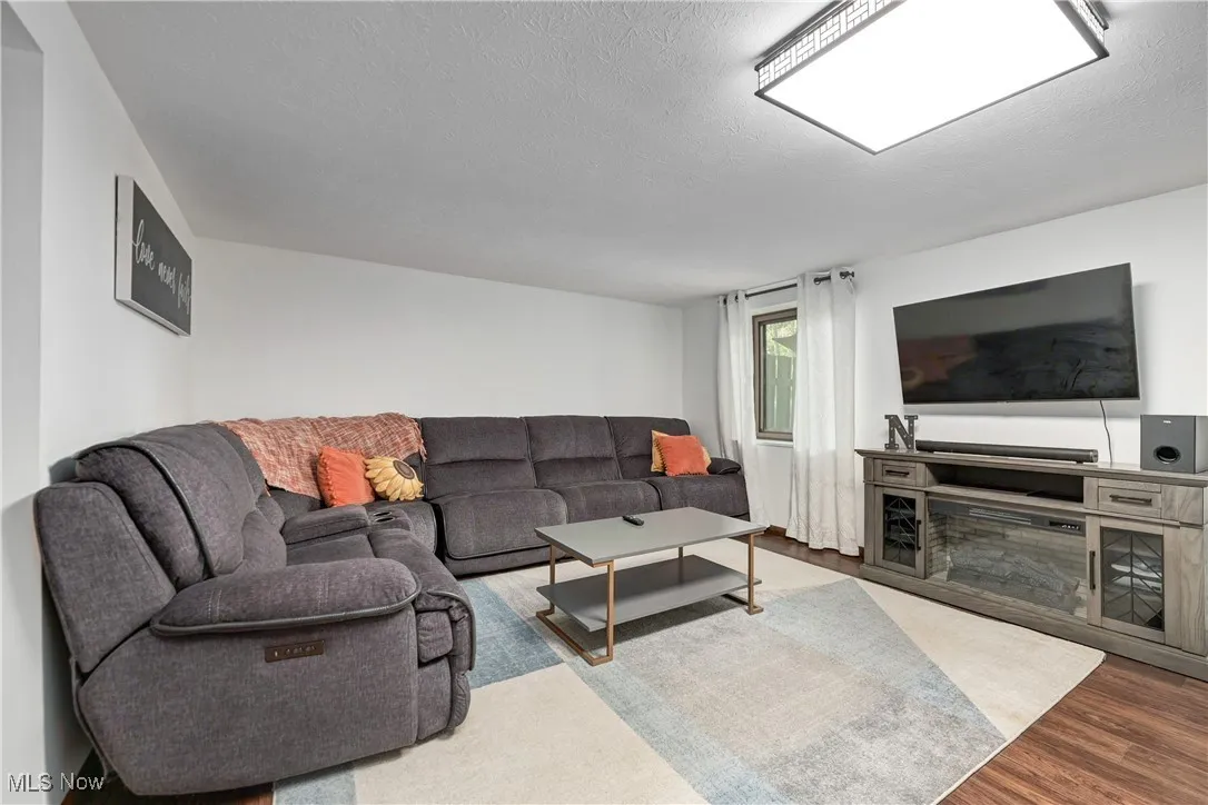 Living area featuring a textured ceiling and wood finished floors