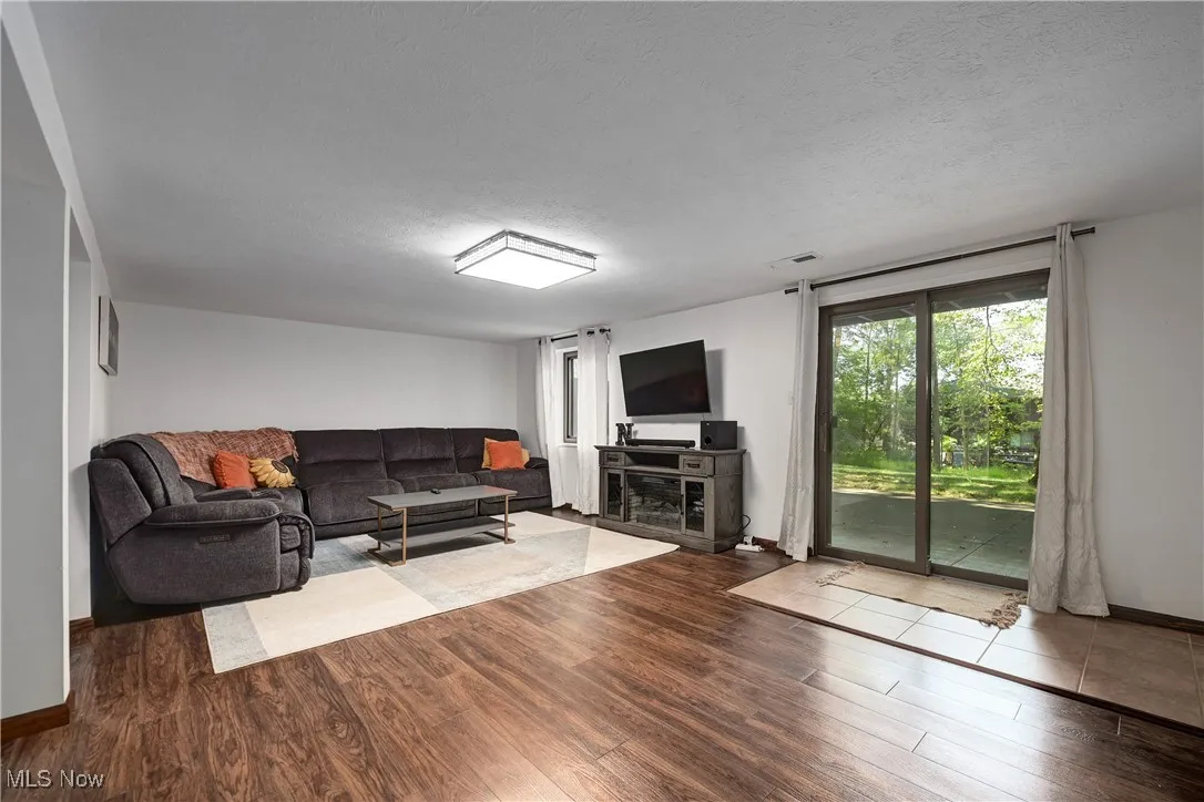 Living room featuring wood finished floors and a textured ceiling
