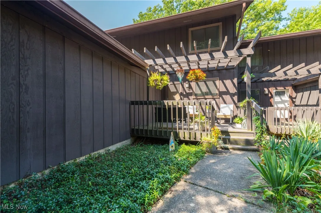 View of side of home featuring a deck