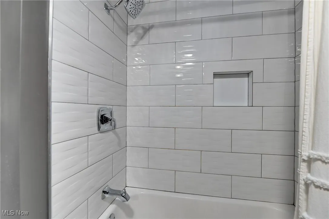Bathroom with shower / bath combo with shower curtain