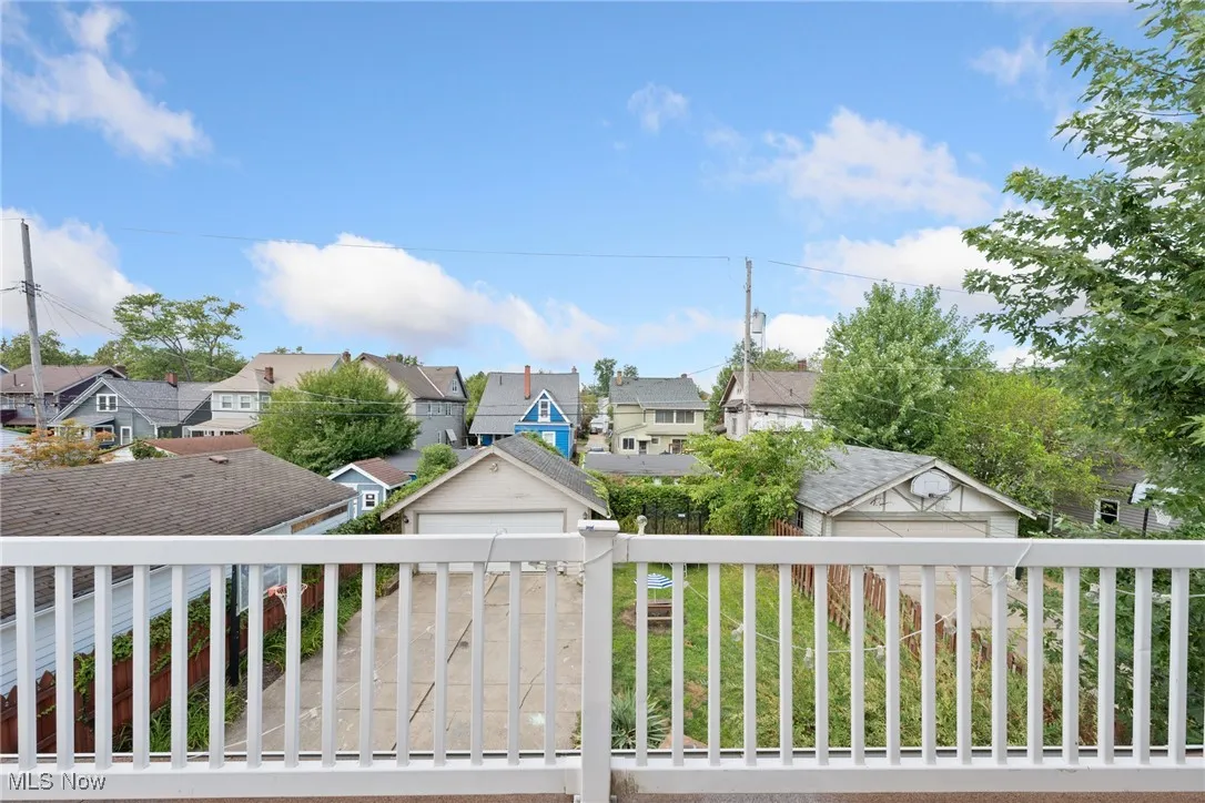 Wooden deck with a residential view and a garage
