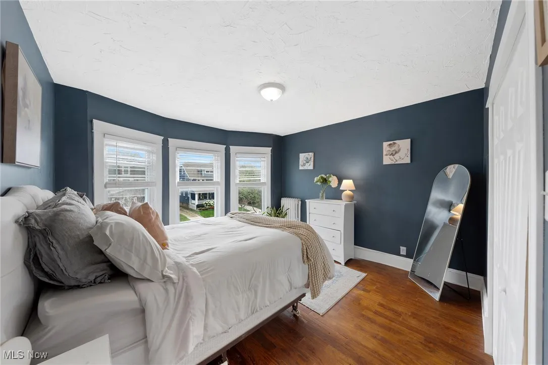 Bedroom featuring wood finished floors and a textured ceiling