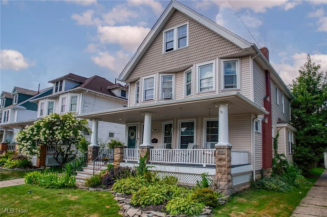Victorian-style house with covered porch and a chimney