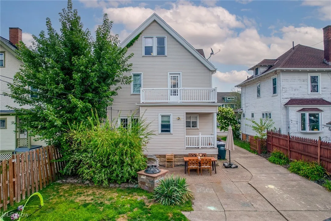 Back of house with a patio area, a balcony, and a fenced backyard