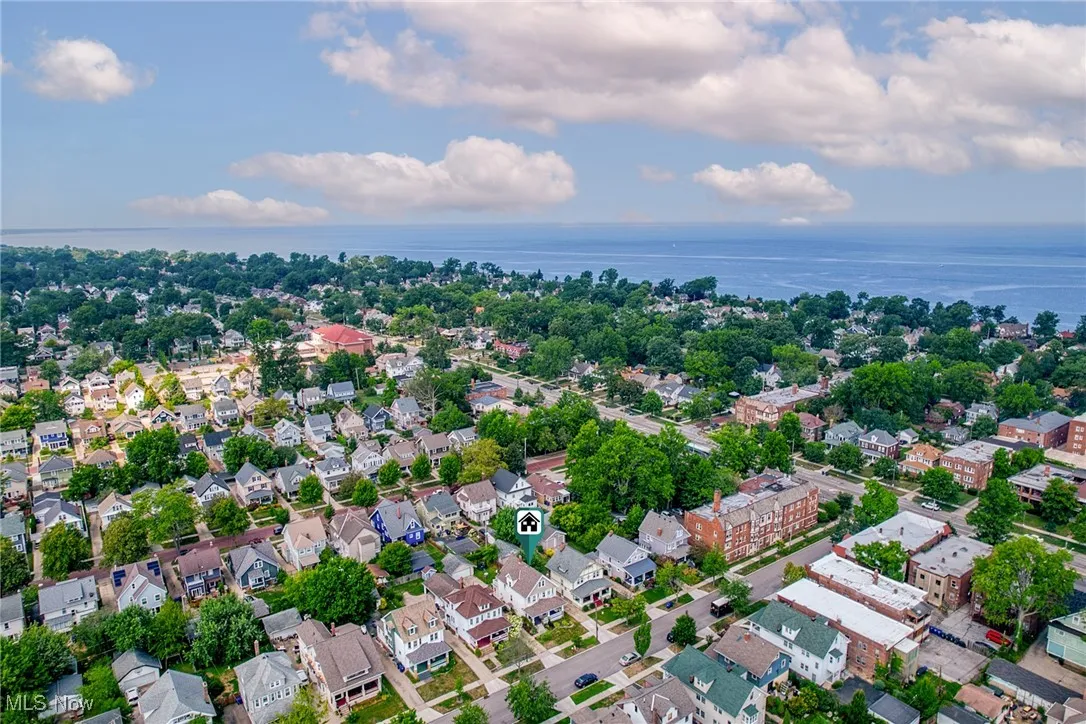 Aerial view of property's location featuring a large body of water and nearby suburban area