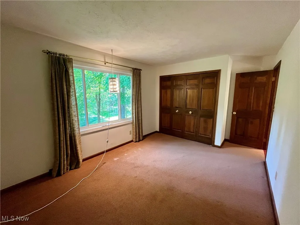 Unfurnished bedroom with carpet, a closet, and a textured ceiling