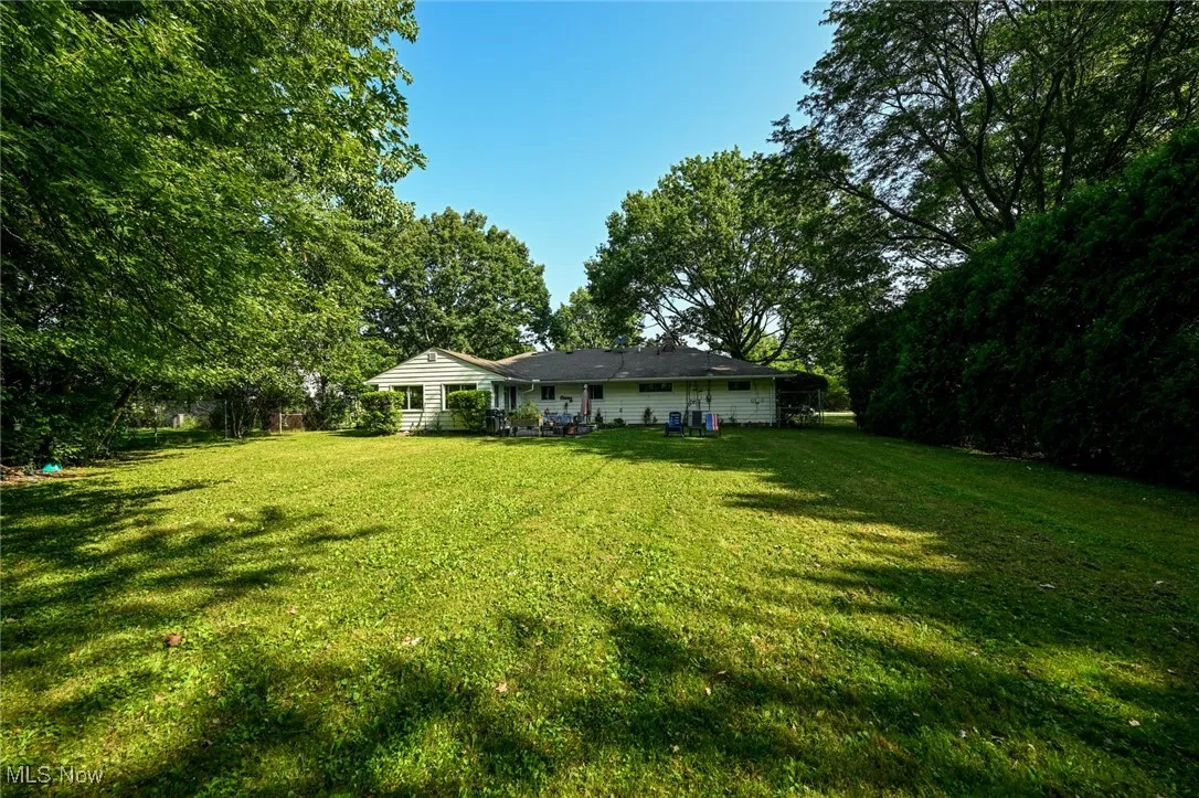 View of the back of the house and patio with firepit.