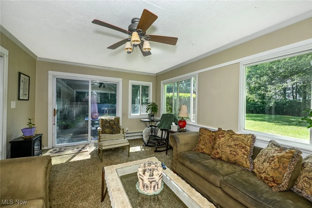 Light and bright sunroom with sliding door to patio.