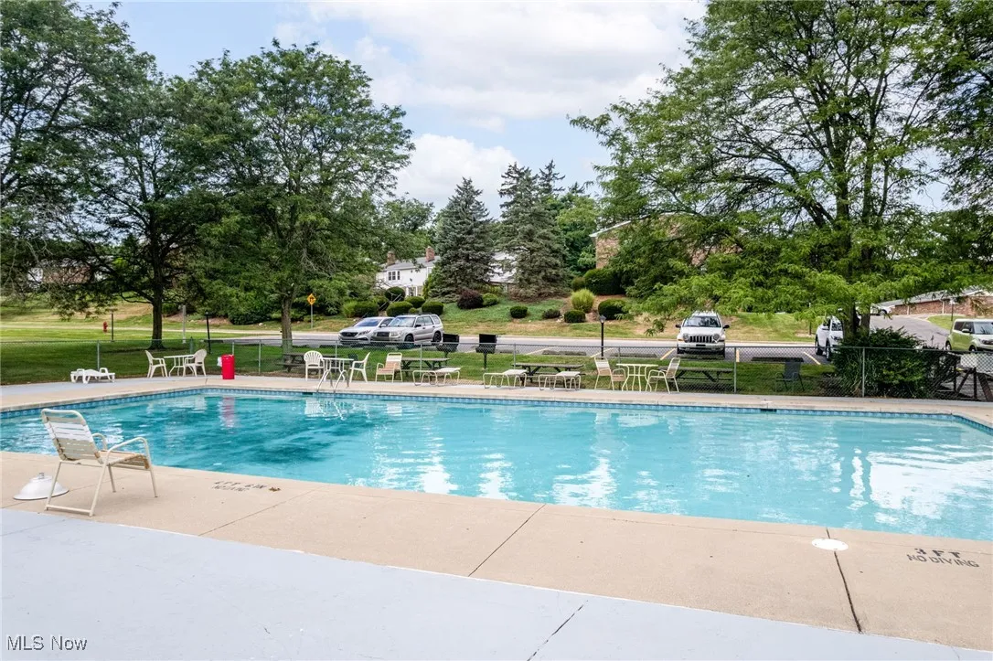 Community pool featuring a patio