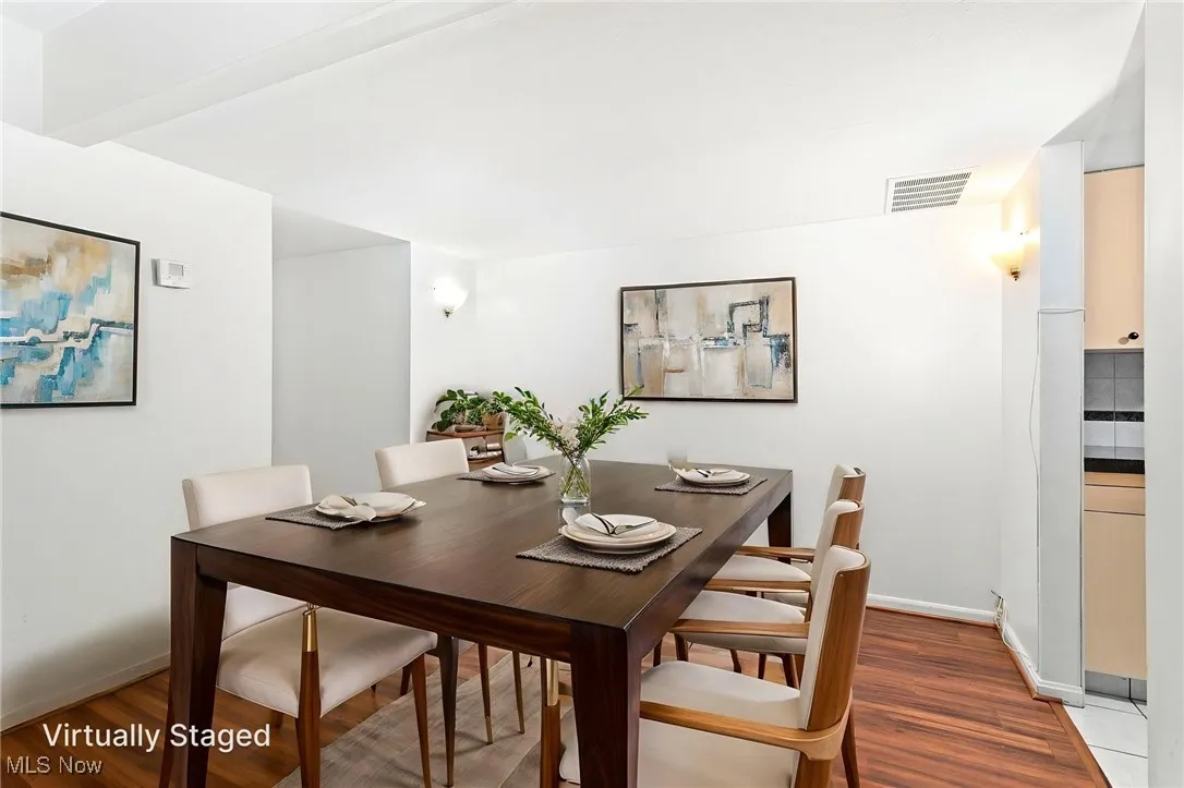 virtually staged Dining room with laminate flooring
