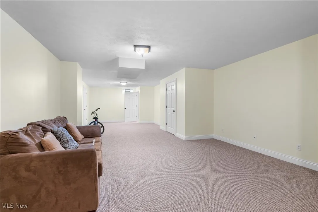 Living room with carpet flooring and baseboards