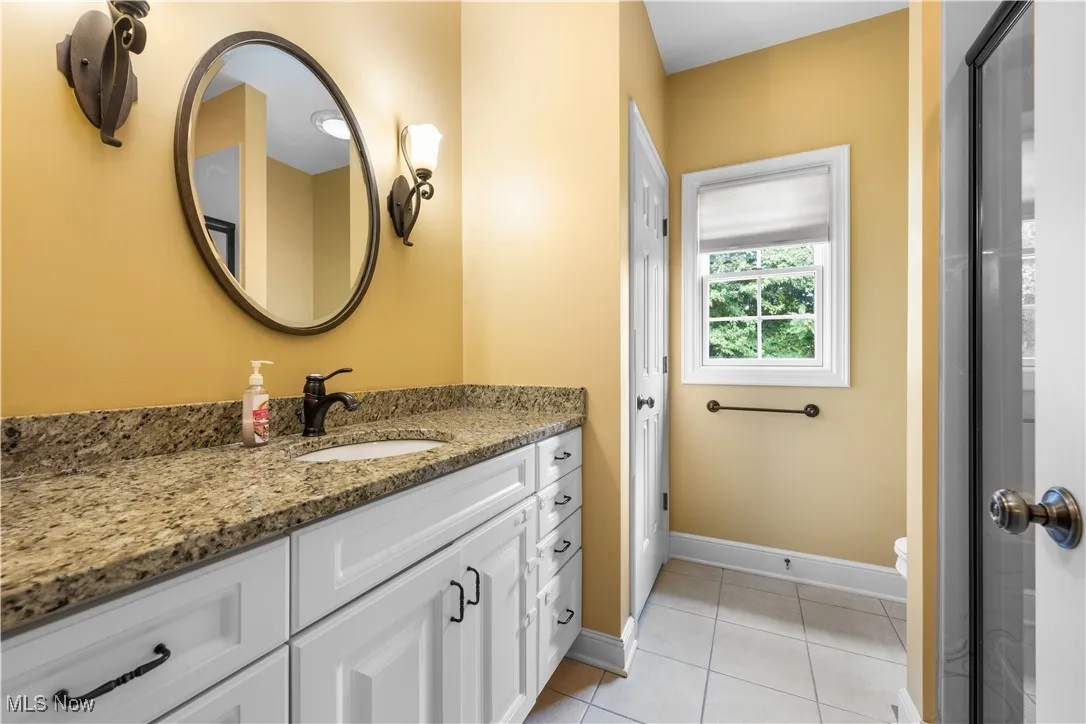 Bathroom featuring vanity and light tile patterned floors