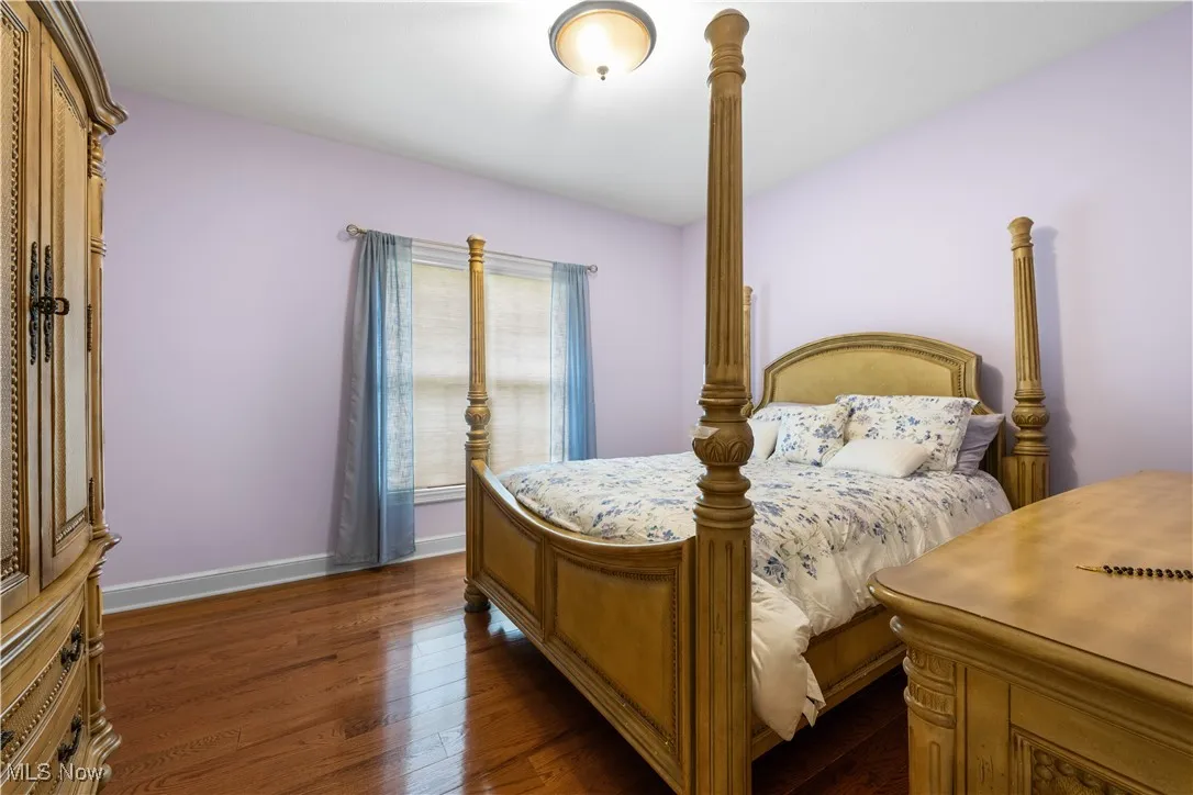 Bedroom featuring baseboards and dark wood finished floors