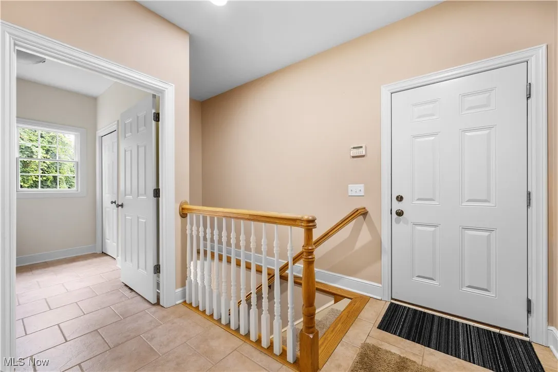 Foyer entrance featuring light tile patterned flooring